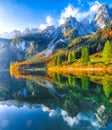 autumn scenery with Dachstein mountain summit reflecting in crystal clear Gosausee mountain lake