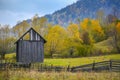 Autumn scenery landscape with colorful forest, wood fences and hay barns in Bucovina, Romania Royalty Free Stock Photo