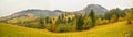 Autumn scenery landscape with colorful forest, wood fences and hay barns in Bucovina, Romania Royalty Free Stock Photo