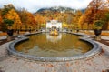 Autumn scenery of Linderhof Palace in Bavaria Germany, with view of a golden statue in the circular fountain pond