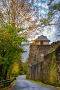 Autumn scenery with roadway along medieval wall of Marksburg Castle. Upper Middle Rhine Valley, Germany