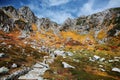 Autumn scenery of rugged mountain peaks and a hiking trail by the mountainside in Senjojiki Cirque