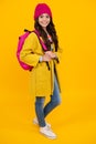 Autumn school. Teenager schoolgirl in school uniform with bagpack. School children on studio background. 1