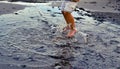 Autumn seashore. A child girl jumps barefoot through the sea puddles. Children`s rest. Happy moments of child