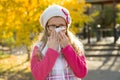 Outdoor portrait of a girl child with a handkerchief on the background of autumn. Royalty Free Stock Photo