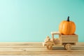 Autumn season concept with toy truck and glitter pumpkin decor on wooden table Royalty Free Stock Photo