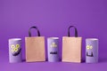 Autumn season Halloween holiday sale concept - toy from toilet roll tube? recycle idea and paper cragt shoppin bag on purple back Royalty Free Stock Photo