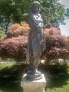 Autumn season represented by statue. Garden of the crystal palace in Porto.