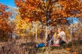 Autumn season walk. Senior couple hugging sitting in park. Man and woman relaxing outdoors Royalty Free Stock Photo