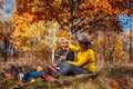 Autumn season walk. Senior couple sitting in park. Man and woman relaxing outdoors having fun Royalty Free Stock Photo