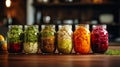 Autumn seasonal pickled or fermented vegetables in jars placed in row over vintage kitchen drawer, white wall background Royalty Free Stock Photo