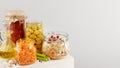 Fermented vegetables, mushrooms and olive oil in glass jars with copy space Royalty Free Stock Photo