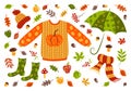 Autumn set: sweater, umbrella, hat, scarf, rubber boots, apples, mushrooms, berries, acorns, yellowing leaves. Demi