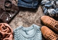 Autumn set of women`s clothing - suede shoes, jeans, knitted pullover, scarf, shoulder bag, accessories on a wooden background, t