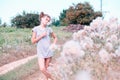 Beautiful Young Woman lying on the field in green grass and blowing dandelion. Outdoors. Enjoy Nature. Healthy Smiling Girl on spr Royalty Free Stock Photo