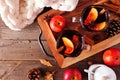 Cozy autumn scene with spiced tea with apples and pomegranates, top view on a wooden tray