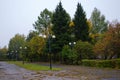 Autumn square in cloudy weather with lanterns