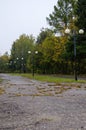 Autumn square in cloudy weather with lanterns