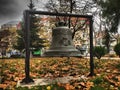 Old iron bell in park in front of church Saint George New Church in Bucharest, Romania.