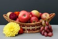 Autumn still life - apples in a basket, grapes and bright flowers Royalty Free Stock Photo