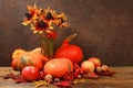 Autumn still life with apples, rowan berries, pumpkins, sunflower flowers on an old wooden table, background, Thanksgiving concept Royalty Free Stock Photo