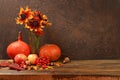Autumn still life with apples, rowan berries, pumpkins, sunflower flowers on an old wooden table, background, Thanksgiving concept Royalty Free Stock Photo