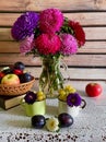 Autumn still life with asters, apples, grapes. Bright colors of autumn.