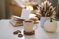 Autumn still life. Coffee cup, flowers, book and pumpkin. Hygge lifestyle, cozy autumn mood. Flat lay, Happy thanksgiving Royalty Free Stock Photo