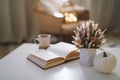 Autumn still life. Coffee cup, flowers, book and pumpkin. Hygge lifestyle, cozy autumn mood. Flat lay, Happy thanksgiving Royalty Free Stock Photo