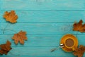 Autumn still life - coffee with leaves on a blue wooden background.