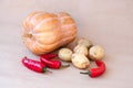 Autumn still life with a crop of vegetables : pumpkin, potatoes and red pepper