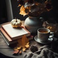 Autumn still life with a cup of hot tea, books, pumpkins and autumn leaves. Royalty Free Stock Photo