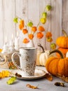 Autumn still life with cup of tea, pumpkins,flowers and candles on table.Thanksgiving day or halloween concept Royalty Free Stock Photo