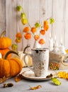 Autumn still life with cup of tea, pumpkins,flowers and candles on table.Thanksgiving day or halloween concept Royalty Free Stock Photo