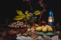 The autumn still life is decorated with a pear, walnut, pumpkin Royalty Free Stock Photo