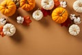 Autumn still life flat lay with pumpkins, cotton, and maple leaves on a rustic brown background Royalty Free Stock Photo