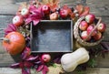 Autumn still life. Fresh fall fruits, ripe apples, pumpkin and wooden tray on table. Copy space. Royalty Free Stock Photo