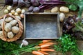Autumn still life. Fresh fall vegetables, carrot, beetroot, onion, garlic, potato and wooden tray on table. Copy space. Royalty Free Stock Photo