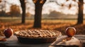 Autumn still life with a freshly baked apple pie cooling on a table with two apples, ready for thanksgiving day dessert Royalty Free Stock Photo