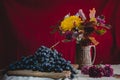 Autumn still life grapes and autumn flowers Royalty Free Stock Photo