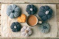 Autumn still life from handcrafted knitted pumpkin, cookie, mug of cocoa, coffee or hot chocolate on baking paper. Concept warm