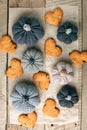 Autumn still life from handcrafted knitted pumpkin, cookies in heart shape on baking paper. Concept warm cozy home fall season