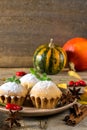 Autumn still life. Homemade cupcakes with powdered sugar with cinnamon sticks, anise stars, pumpkins, Royalty Free Stock Photo