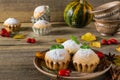 Autumn still life. Homemade cupcakes with powdered sugar with cinnamon sticks, anise stars, pumpkins, berries of rosehip and autum Royalty Free Stock Photo