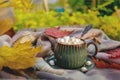 Autumn still life with hot coffee with marshmallows on the street. Side view. A cup of coffee on a diagonal wooden Royalty Free Stock Photo