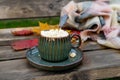 Autumn still life with hot coffee with marshmallows on the street. Side view. A cup of coffee on a diagonal wooden Royalty Free Stock Photo