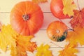 Autumn still life, maple leaves and orange pumpkins Royalty Free Stock Photo