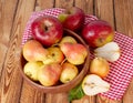 Autumn still life. Pear and apple on wooden table with red checkered tablecloth. Pears and apples flat lay overhead