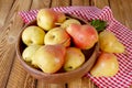 Autumn still life. Pear fruit on wooden table with red checkered tablecloth. Rustic design Royalty Free Stock Photo