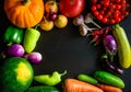 Autumn still life with pumpkin, watermelon, and a variety of colorful vegetables on black wooden background. Happy Thanksgiving Royalty Free Stock Photo